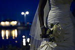 Wedding photograph of the Hamilton Waterfront at night with flowers and dress in the foreground