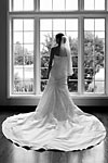 Wedding photograph of a bride in a beautiful dress in front of a window