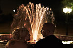 Romantic wedding night photograph of a bride and groom in front of a lit fountain at Carmens in Hamilton